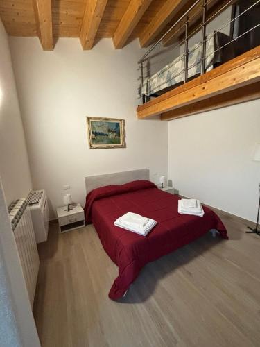 a bedroom with a red bed in a room at Dream House Castellana in Castellana Sicula