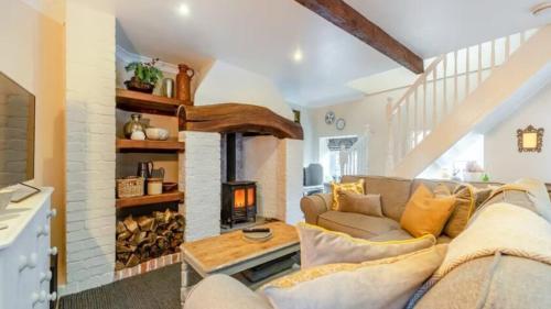 a living room with a couch and a fireplace at The Stable, Cuffern Manor Cottages in Haverfordwest