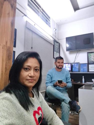 a woman sitting next to a man in a room at The PALM SUITES , Incredible India Tourism in Guwahati