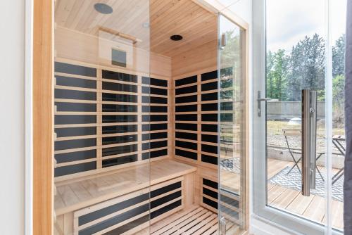 a sauna with glass doors and a deck at L'héritage & SPA in Lyon