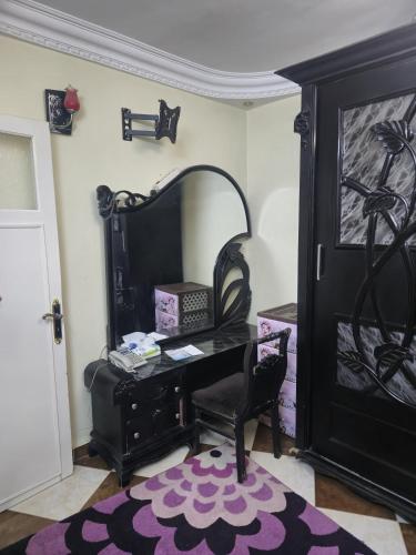 a room with a desk and a chair and a door at Lovely two bedrooms apartment in Asyut city in Asyut