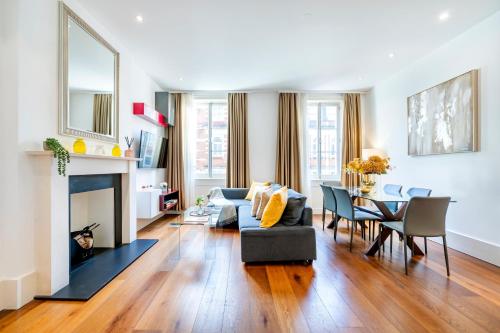 a living room with a couch and a table at Welcome London Mayfair in London