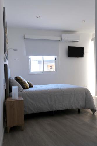 a bedroom with a large bed and a window at JVG VILLAS - Villa Giulia in Güimar