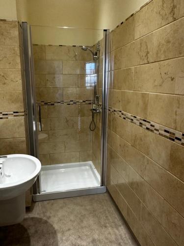 a bathroom with a shower and a sink at Ecclefechan Hotel in Ecclefechan