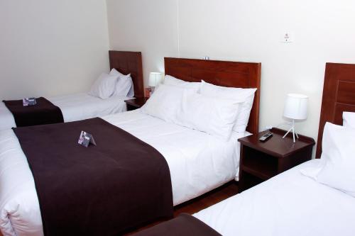a hotel room with two beds and two night stands at Colca Canyon Hotel by PERU HTL in Chivay