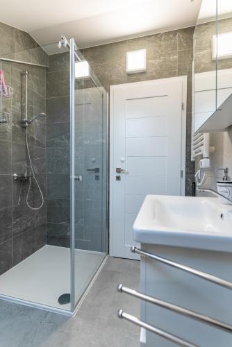 a bathroom with a shower and a sink at Apartman Kačićeva in Vukovar