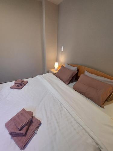a large white bed with two towels on it at River Studio in Vasilikí