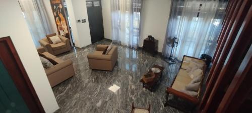 an aerial view of a living room with couches and chairs at Sella Villa in Seeduwa