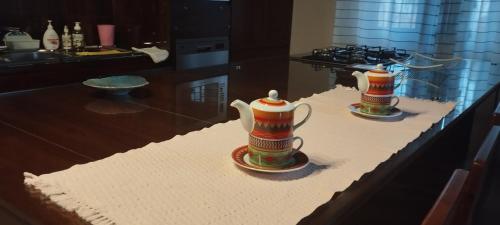 two tea cups sitting on a table in a kitchen at Sella Villa in Seeduwa