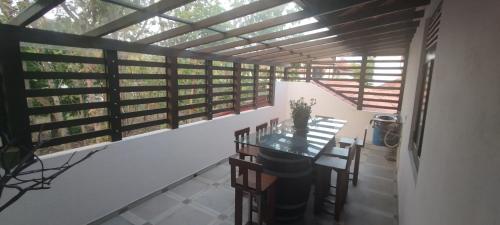 a room with a table and chairs on a balcony at Sella Villa in Seeduwa