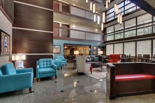a lobby with couches and chairs and tables at Heritage Inn & Suites The Woodlands, Trademark by Wyndham in The Woodlands