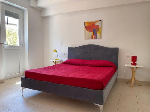 a bedroom with a large bed with a red blanket at Casalago in Bolsena