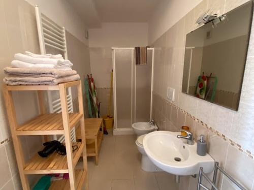 a bathroom with a sink and a toilet and a mirror at Casalago in Bolsena