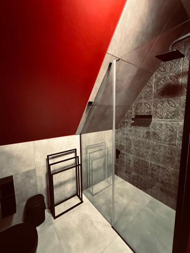 a glass shower in a bathroom with a red ceiling at Leśny Wierch luxury spa villas in Bukowina Tatrzańska