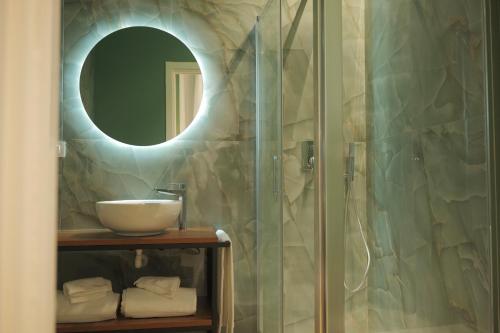 a bathroom with a shower with a sink and a mirror at Toledo LR Collection in Naples