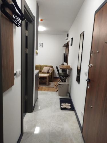 a hallway with a door and a living room at Bella Winterhouse Kopaonik in Kopaonik