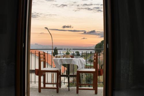 a table on a balcony with a view of the water at Casa per l'Osticcio con Vista Panoramica in Montalcino