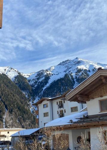 a resort with snow covered mountains in the background at Apart Resi in Niederthai