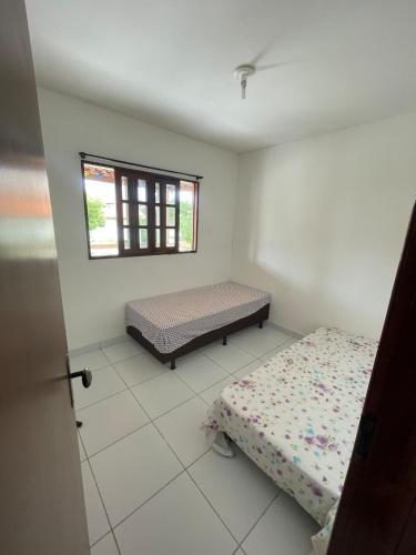 a bedroom with a bed and a window at Chã Grande - Cantinho Premium in Chã Grande