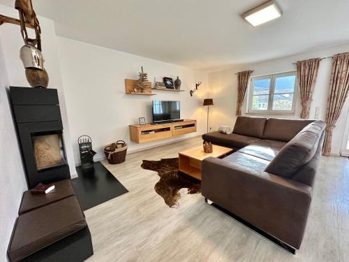 a living room with a couch and a fireplace at Schofer Eck - fewo-badhindelang in Bad Hindelang