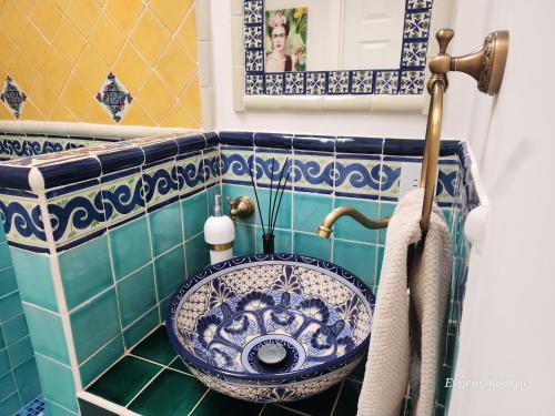 a bathroom with a blue and white sink at Casa Blanca Boutique & Organic in Cancún