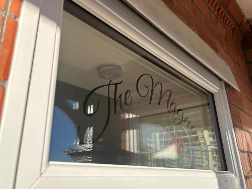 a window with the end written on it at The Magnolia in Rhôs-on-Sea