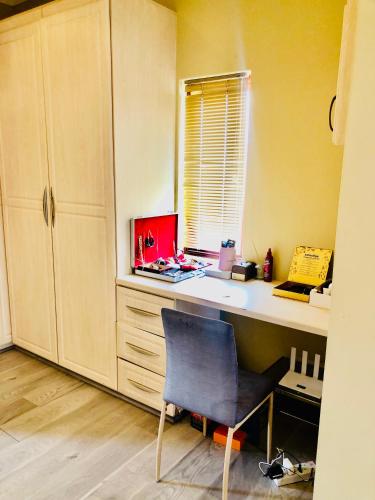an office with a desk with a chair and a window at Cloud 9 Elevate your Stay in Nelspruit