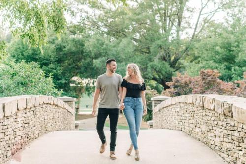 a man and a woman walking across a bridge at Pet Friendly 3BR House in Charlotte in Charlotte