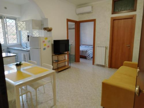 a kitchen and living room with a refrigerator and a table at A Casa di MiVa in Santa Maria delle Mole