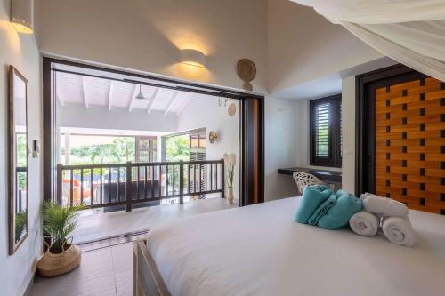 a bedroom with a large bed and a balcony at Blue Bay's Tropical Escape in Willemstad