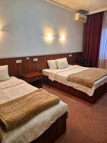 a hotel room with two beds in a room at Vila Oxa in Novi Pazar