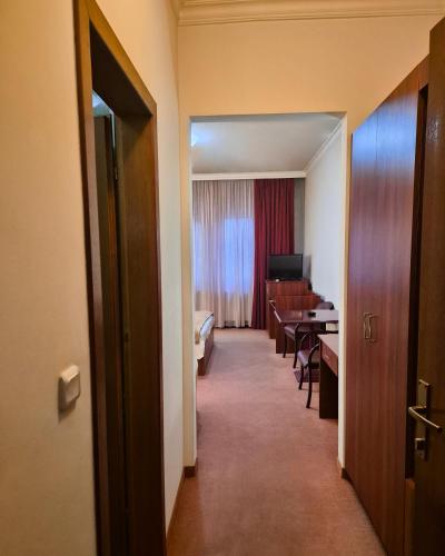 a corridor of a hotel room with a dining room at Vila Oxa in Novi Pazar