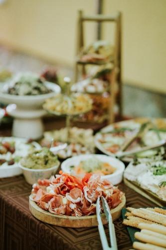 a table with many different types of food on it at Joyard - Pensiune & Parc in Porumbacu de Sus