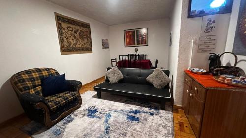 a living room with a couch and a chair at Casa Amarela - Aldeias - Serra da Estrela in Gouveia