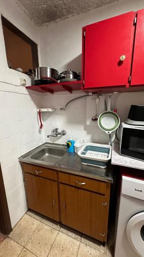 a small kitchen with a sink and a stove at Casa Amarela - Aldeias - Serra da Estrela in Gouveia
