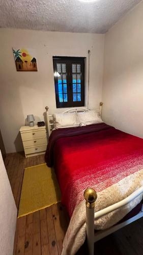 a bedroom with a large bed and a window at Casa Amarela - Aldeias - Serra da Estrela in Gouveia