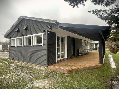 a house with a porch and a deck at Olde Villa in Meegomäe