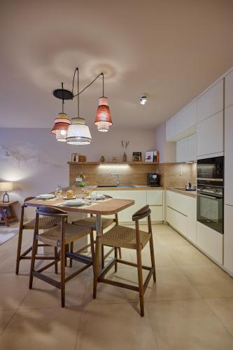 a kitchen with a table and chairs in a room at Le Miroir De Saint-Jacques in Sallanches