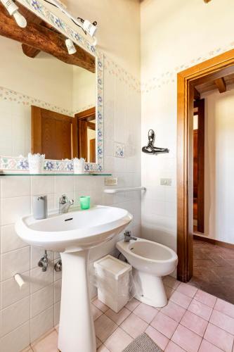 a bathroom with a sink and a toilet at Casa di Romano - La Loggia in Marcialla