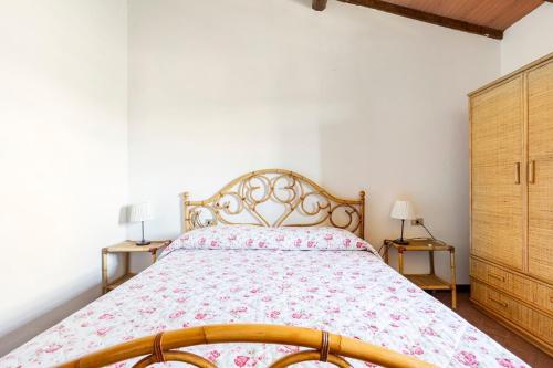 a bedroom with a large bed and two night stands at Casa di Romano - La Loggia in Marcialla