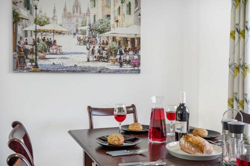 a table with plates of food and glasses of wine at Disc-counts For Family & Work stays, Coffee machine - Fast wifi - Free parking - Private Garden in Borehamwood