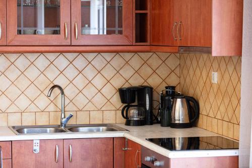 a kitchen with a sink and a coffee maker at Domas Blue Studio Villa With Private Pool and Panoramic View in Loutra