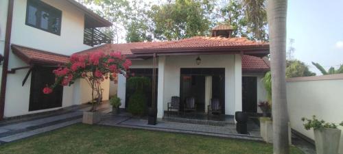 a small white house with a red roof at Sella Villa in Seeduwa