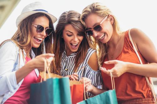 three women laughing while looking at shopping bags at Glunz Ocean Beach Hotel and Resort in Marathon