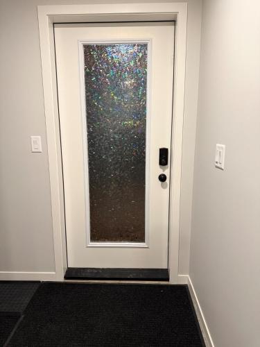 a door with a window in a room at Relax, Recharge, Repeat 2Bedroom Walkout Haven in Calgary