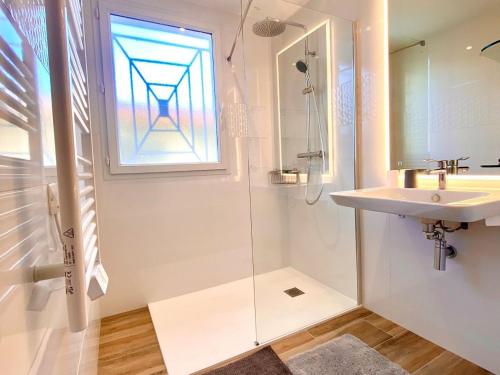 une salle de bain avec un lavabo et une douche avec une fenêtre dans l'établissement Bel appartement climatisé à Mèze avec parking et accès à la plage - FR-1-604-20, à Mèze