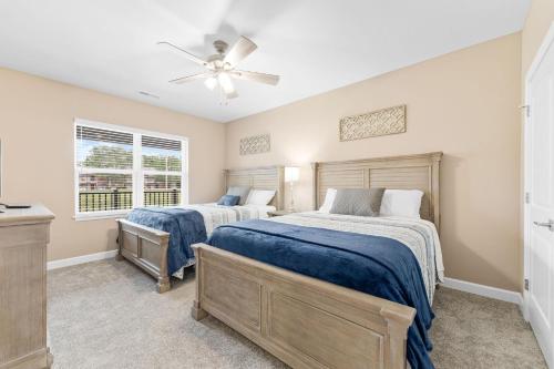 a bedroom with two beds and a ceiling fan at Spacious Retreat, Heart of the City, Indoor Pool, Free Attraction Tickets! in Branson