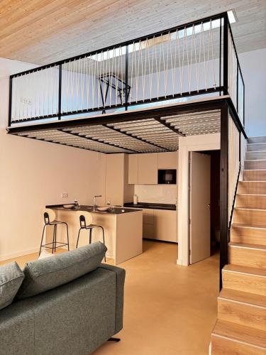 a living room with a staircase and a couch at VUT La Casa de la Sierra in El Barraco