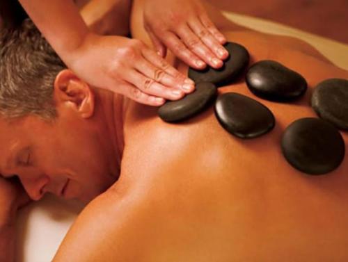 a man getting a massage with rocks on his back at ROOMS for rent in Mexico City