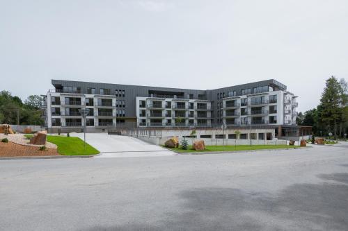 an empty parking lot in front of a building at BREZOVINA Apartmán Pohoda Orava in Veselé